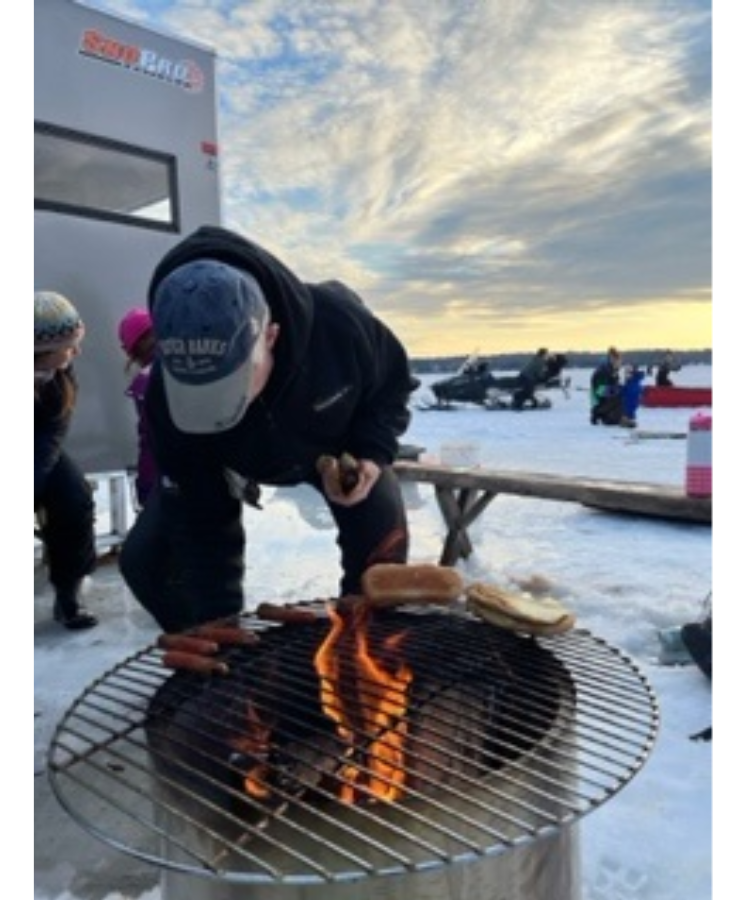 Person cooking at fire